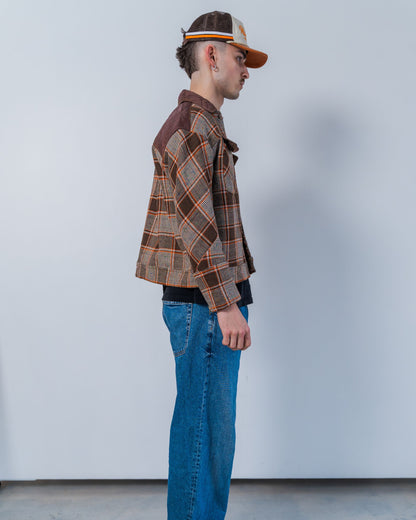 Person wearing a brown wool plaid jacket made with sustainable upcycled materials.