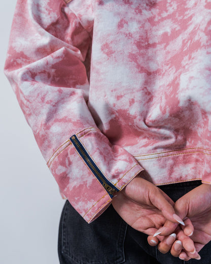 Close-up of zipper details on a pink tie-dye jacket with made from sustainable upcycled materials on a white background