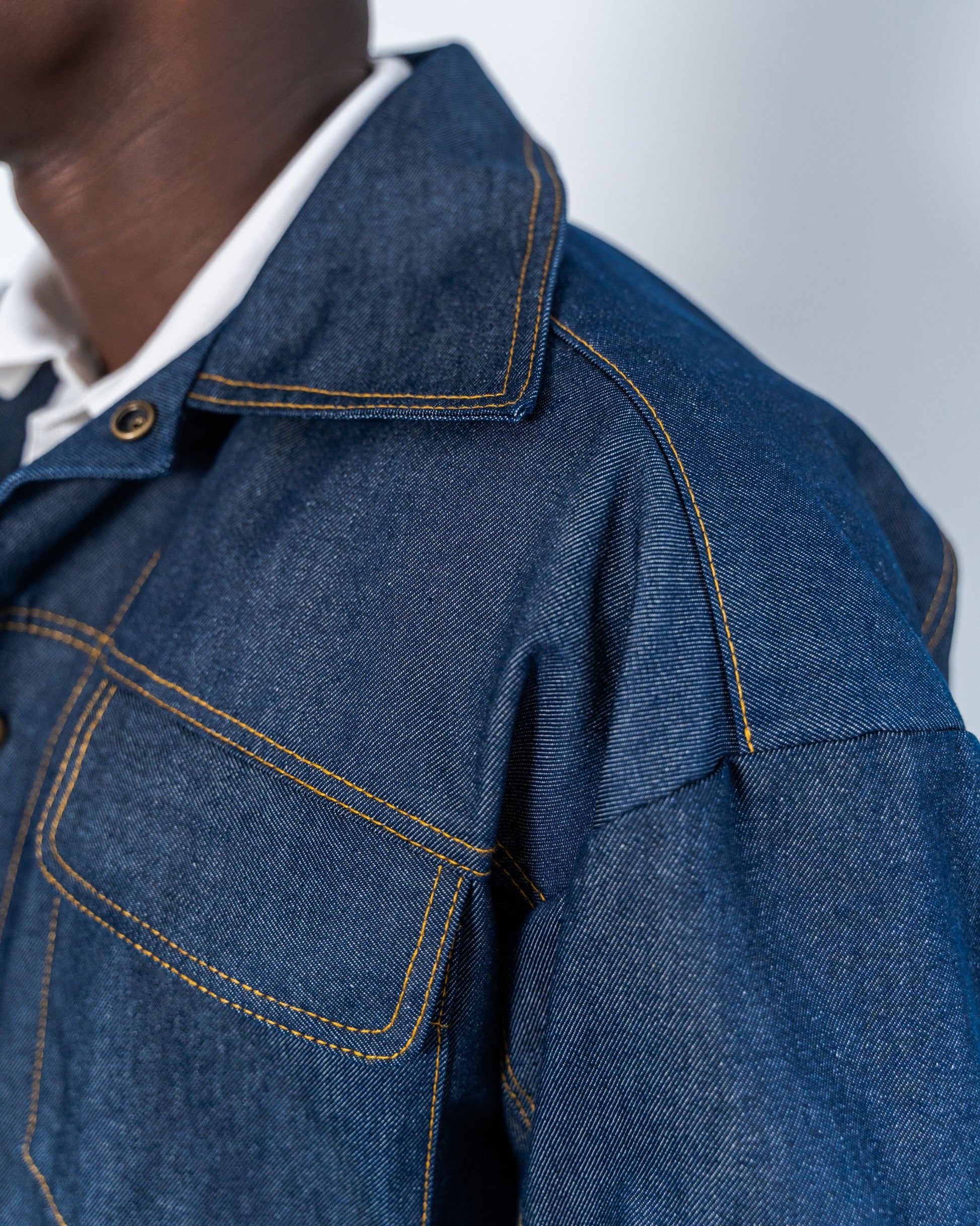 Close-up of a blue denim jacket with denim thread top stitching